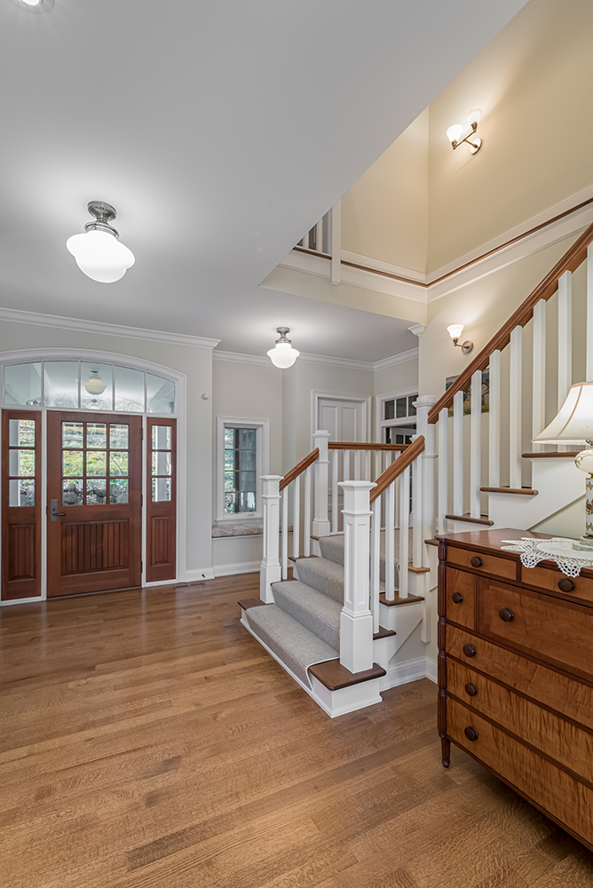 lake-house-historic-charm-front-door-entryway-staircase-railing